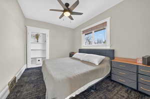Primary Bedroom featuring dark carpet and ceiling fan