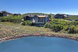 Rear view of property featuring a water view and a residential view