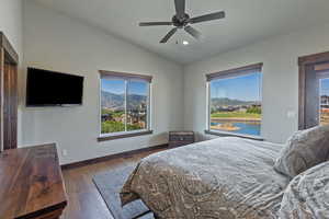 Bedroom with a mountain view, lofted ceiling, hardwood / wood-style floors, a ceiling fan, and recessed lighting