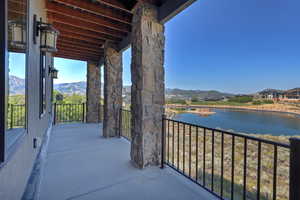 Balcony with a water and mountain view