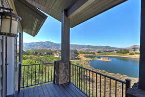 Deck with a water and mountain view