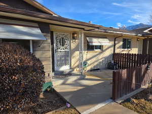 Entrance to property featuring brick siding and a mountain view