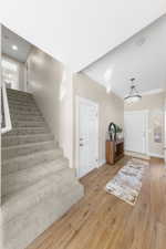 Entryway featuring wood finished floors and ornamental molding