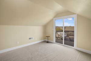 Additional living space featuring baseboards and carpet floors