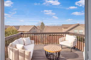 Wooden deck featuring an outdoor hangout area and a residential view