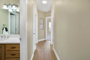 Hall featuring baseboards and light wood-style flooring