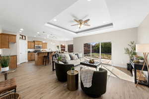 Living room featuring recessed lighting, light wood-type flooring, and ceiling fan