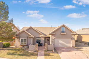 View of front of home featuring driveway, stucco siding, a garage, and a tile roof