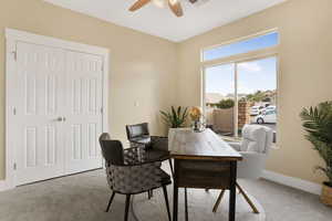 Office area with carpet and ceiling fan