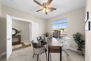 Office featuring light colored carpet and a ceiling fan