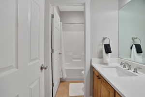 Bathroom featuring vanity, shower / tub combo with curtain, and light tile patterned floors
