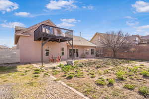 Back of property with a fenced backyard, a patio area, and stucco siding