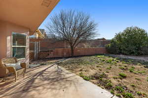 Fenced backyard with a patio