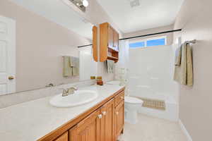 Bathroom with shower / tub combo with curtain and vanity