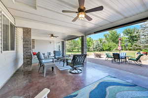 View of patio featuring an outdoor living space with a fire pit, ceiling fan, and outdoor dining area