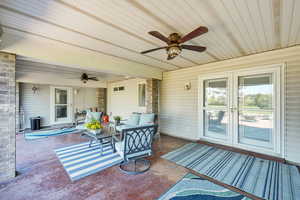 View of patio / terrace with ceiling fan, an outdoor living space, and french doors