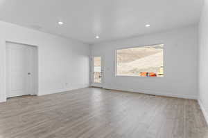 Unfurnished room featuring light wood-style flooring and recessed lighting