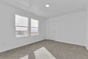 Unfurnished room with baseboards and light carpet
