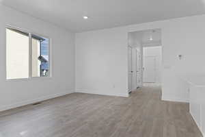 Spare room with light wood-style floors and baseboards