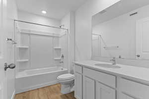 Full bathroom with vanity, light wood-type flooring, and bathing tub / shower combination