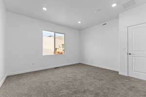 Spare room with light colored carpet and recessed lighting