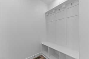 Mudroom with baseboards and wood finished floors