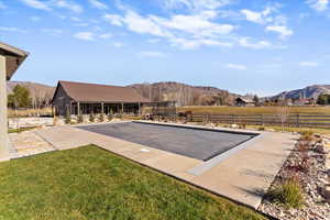 View of pool featuring a mountain view and a trampoline