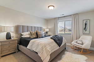 Bedroom featuring carpet flooring and baseboards