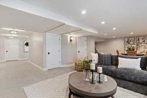 Carpeted living room with baseboards and recessed lighting