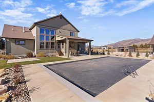 Rear view of house featuring a patio area, a mountain view, and stucco siding