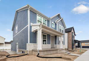 View of home's exterior featuring covered porch and stone siding