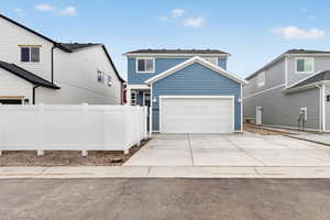 View of front of house featuring driveway and a garage