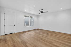 Unfurnished room featuring a ceiling fan, recessed lighting, and light wood-style floors