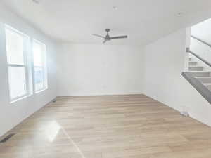 Unfurnished room featuring light wood-style floors, ceiling fan, and recessed lighting
