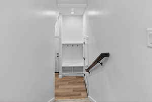 Stairway featuring wood finished floors and recessed lighting