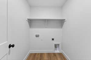 Laundry room featuring hookup for an electric dryer, wood finished floors, and hookup for a washing machine