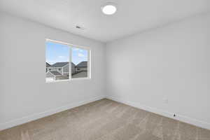 Unfurnished room with baseboards and light carpet