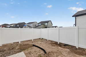 Fenced backyard with a residential view
