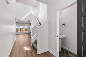 Staircase featuring healthy amount of natural light and wood finished floors
