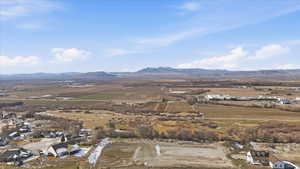 View of rural area with a mountain backdrop and nearby suburban area