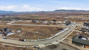 Aerial view of property and surrounding area with mountains and nearby suburban area