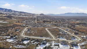 Snowy aerial view with a mountain view and a residential view