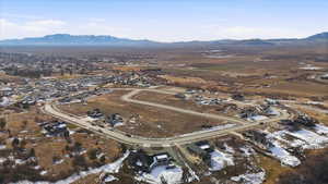 Aerial overview of property's location featuring mountains and nearby suburban area
