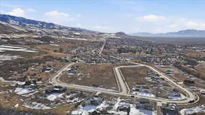 Snowy aerial view with a mountain view and a residential view