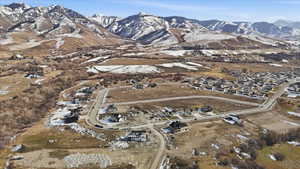 View of property location with mountains and nearby suburban area