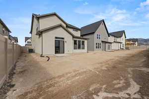 Rear view of property featuring a fenced backyard, stucco siding, and a residential view