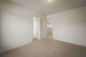 Carpeted empty room with baseboards