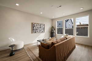 Living room featuring wood finished floors and recessed lighting