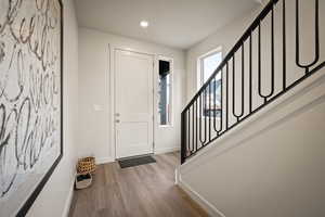 Entrance foyer with recessed lighting and wood finished floors