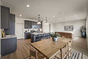Dining area featuring dark wood-style flooring and recessed lighting